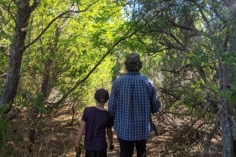 Boy and dad entering the woods 