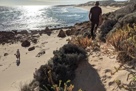 Roland and Andrew on the beach picking trash