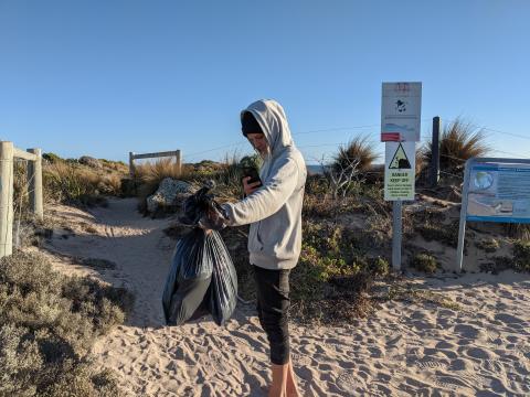 Teen holding the trash he collected