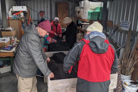 group of volunteers working in the shed