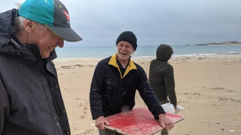 volunteers in a windy rainy beach