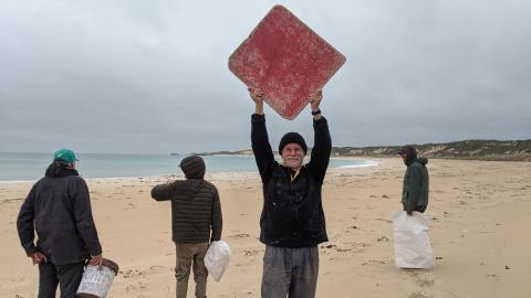 volunteers in a windy rainy beach