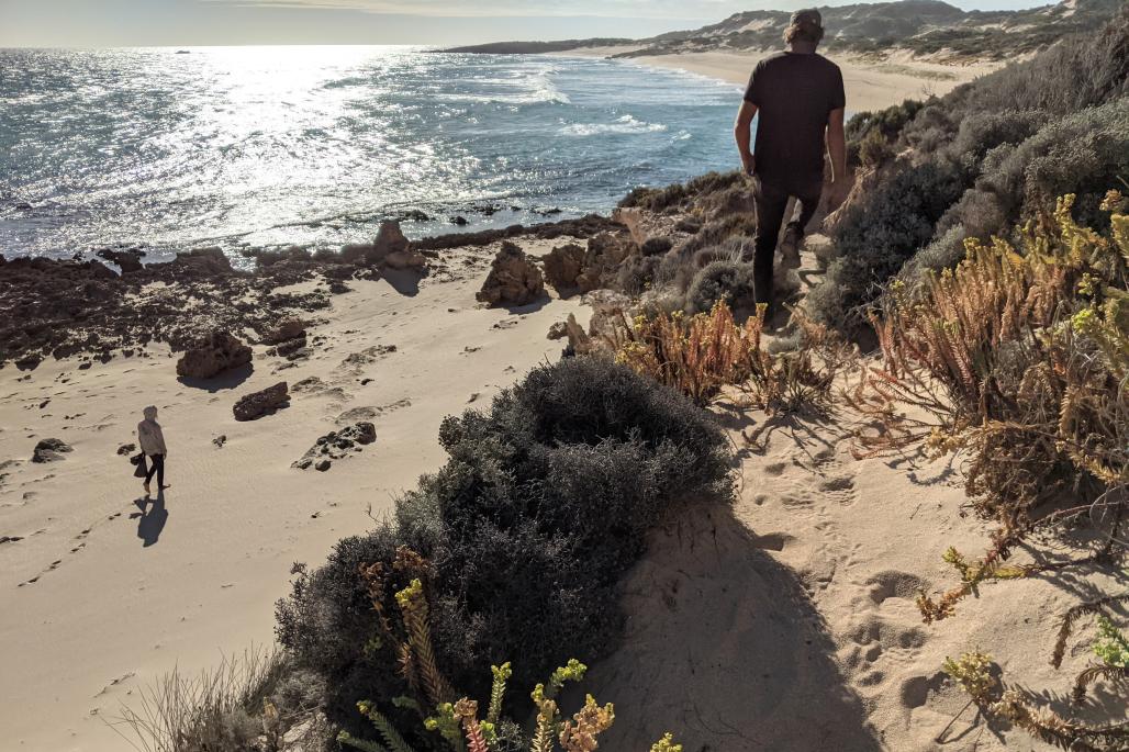 Roland and Andrew on the beach picking trash