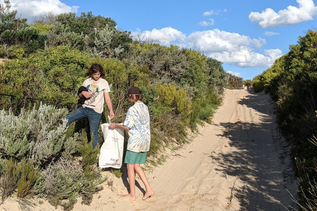 teen volunteers on the track picking up trash