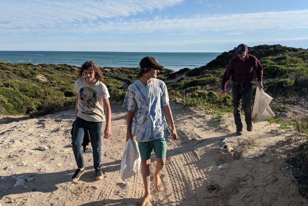 teen volunteers on the track picking up trash