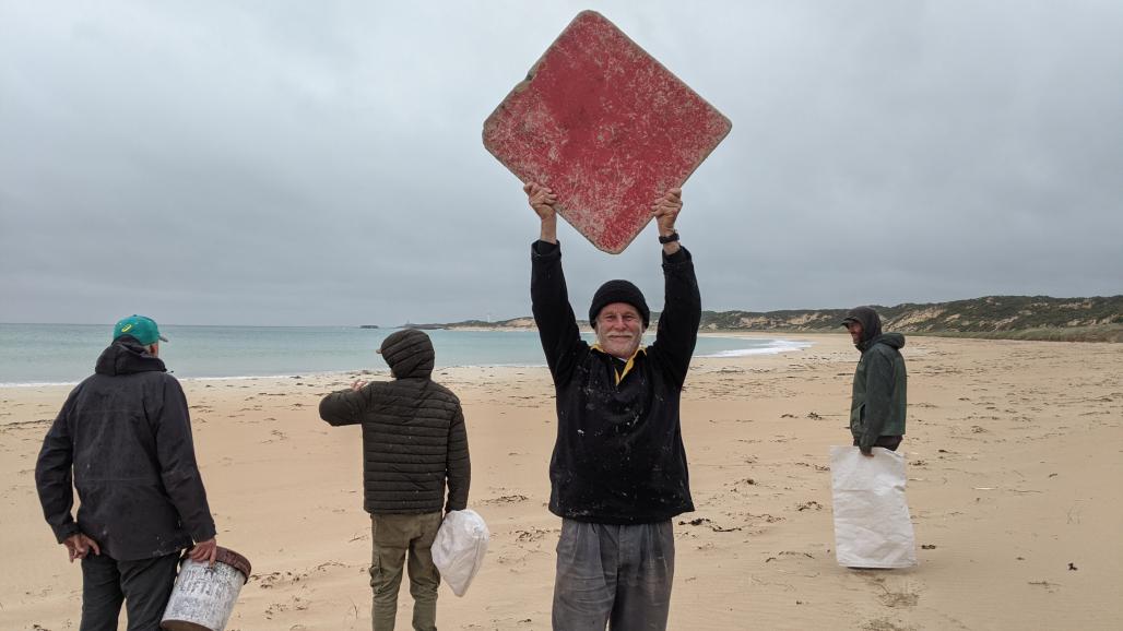 volunteers in a windy rainy beach