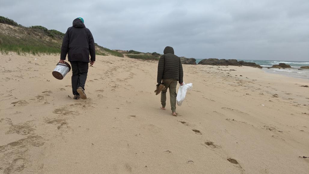 volunteers in a windy rainy beach